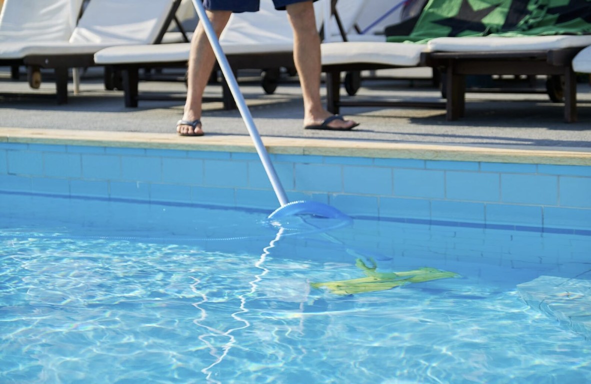 Professional pool technician cleaning swimming pool in Sanford, FL